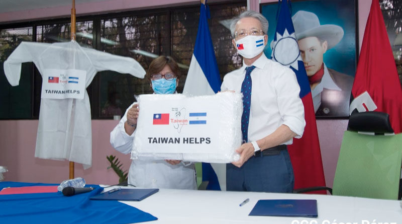 Ministra de Salud, Martha Reyes junto al Embajador de Taiwán, Jaime Chin Mu wu sosteniendo una de las batas