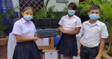 Niños estudiantes sosteniendo un teclado de computadora