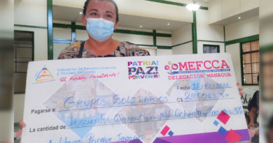 Protagonista de MEFCCA recibiendo cheque como parte del programa emprendimiento para el campo.