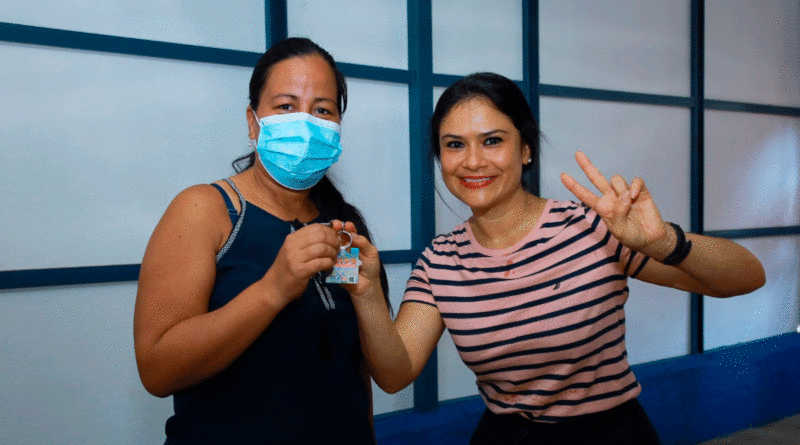 Doña Ana Rebeca Díaz recibiendo las llaves de su nueva vivienda de manos de la secretaria del Concejo Municipal, Jennifer Porras.